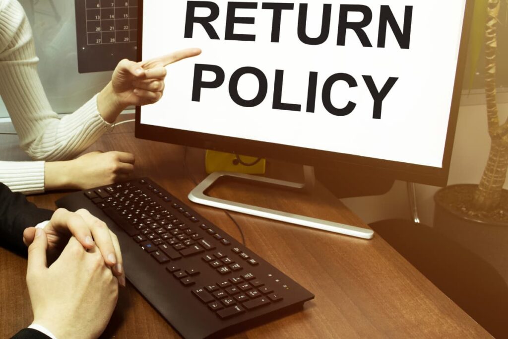 A men and women were looking into the computer which shows there is Return Policy at Lowe's