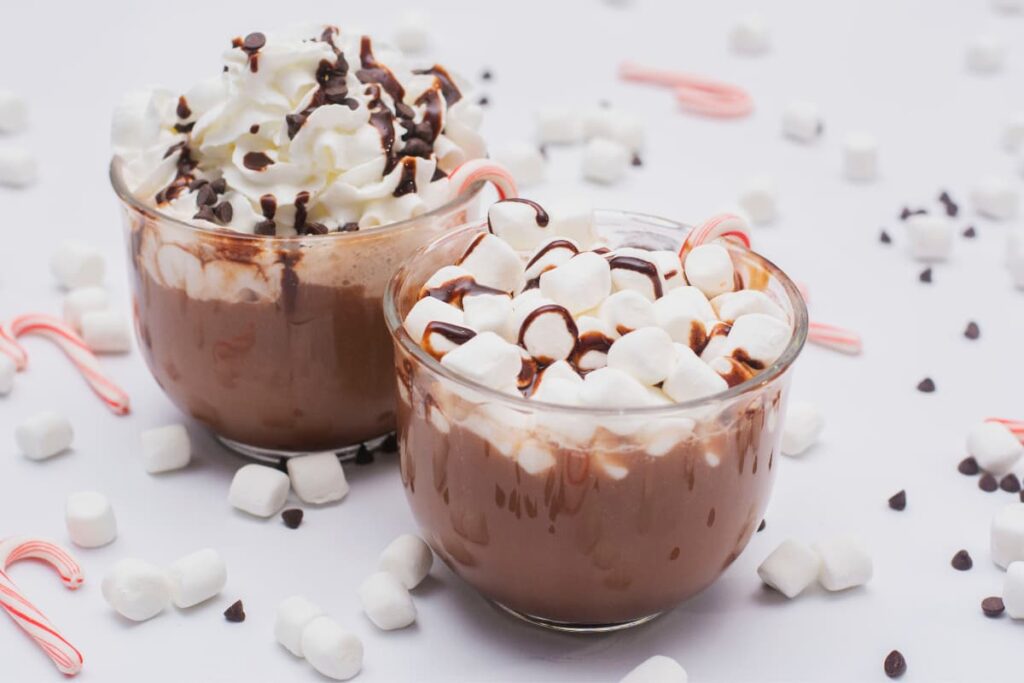 Wendy's Hot Chocolate has 2 cups of Hot chocolate topped with whipping cream, Vanilla mini Marshmallow and chocolate syrup surrounded with Vanilla mini Marshmallow, Peppermint Cotton Candy and Choco chips.