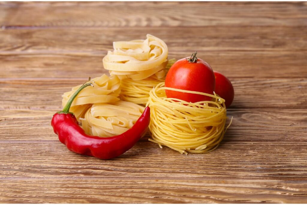 Wendy's Chili pepper with Cherry Tomatoes and Noodles placed on a wooden table