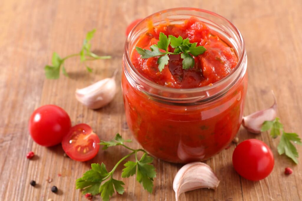 Chick Fil A Sauces Need To Be Refrigerated, Chick fil a sauce can be store in a glass bottle and it is red in color. Beside the sauces there are 2 tomatoes, one is half cut, some garlic cloves, and some coriander leaves which are in the floor.