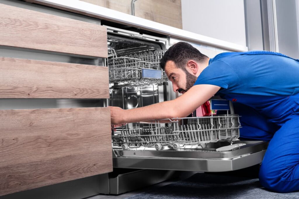 An expert technician from Lowe's is installing the dishwasher.