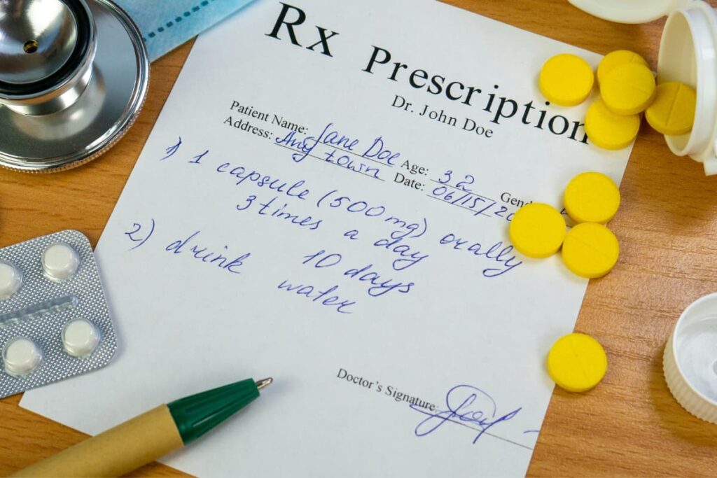 Walmart Deliver Prescriptions  process contains prescription letter, stethoscope, pen, tablets on a wooden table.