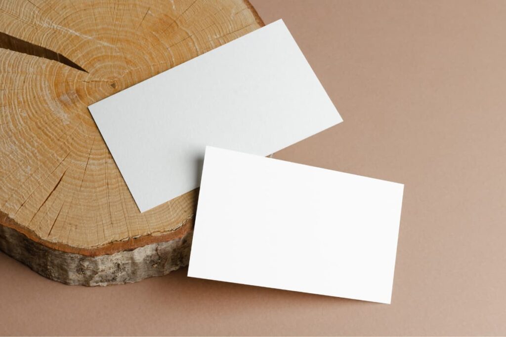 Walmart business cards printed in different sizes and put them on a wooden slice.