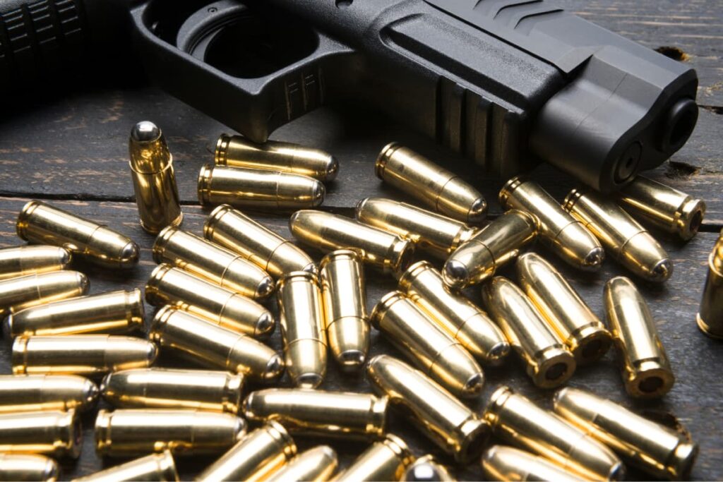 Walmart Ammo with lot of bullets and Gun on a wooden table.