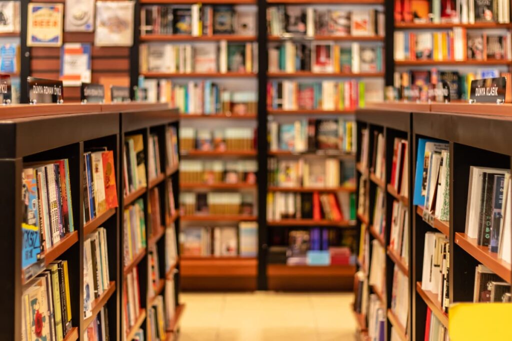 Walmart Books appeared in a large library which is having all kinds of books in a wooden shelfs.