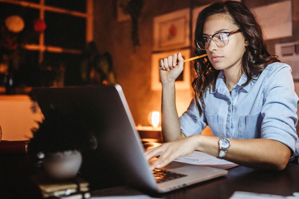 Shifts At Walmart worked as a night shift position in front of her laptop holding a pencil. 