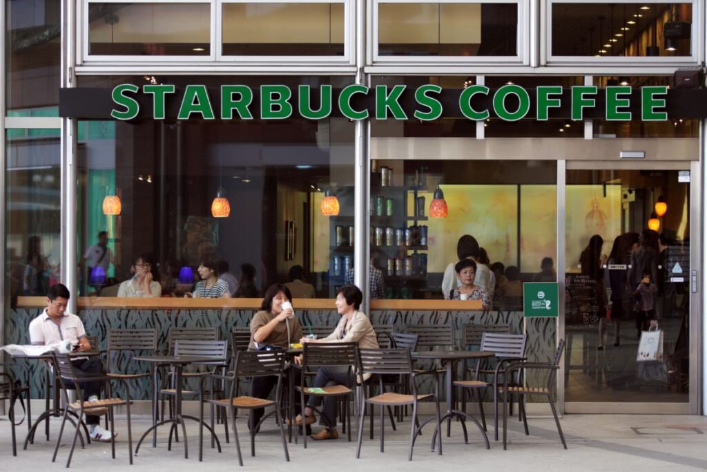 Starbucks Reserves stores are place to sit and eat with friends and family members. This starbucks reserve store has some chairs and tables to sit and have food, some people sat overthere and having their favorites. 