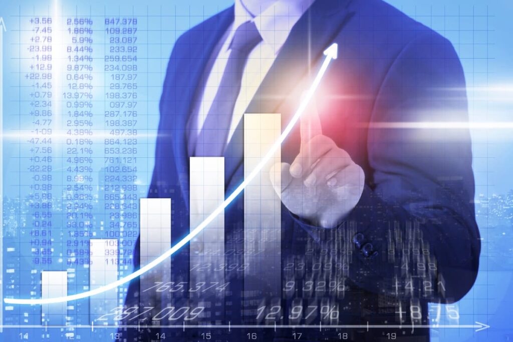 Starbucks Worth describes in a graph. A person stands and pointing his finger to the graph, which is towards up arrow. In a screen there are decimals, percentages, numbers which indicates Stabucks worth and profits.