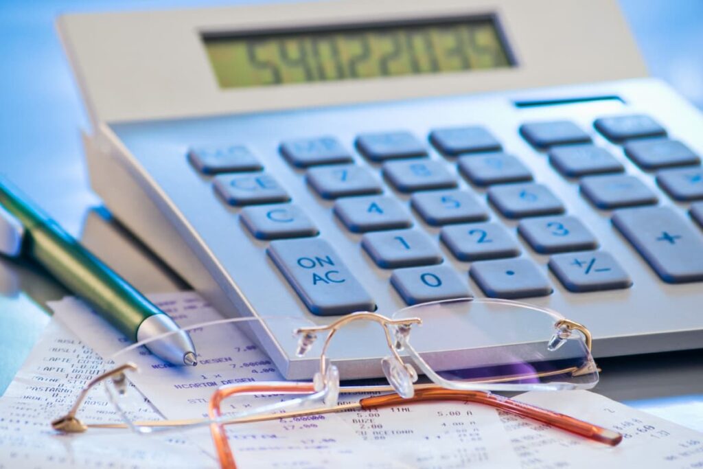 Fake Walmart Receipts along with calculator, spectacles, pen on a table.