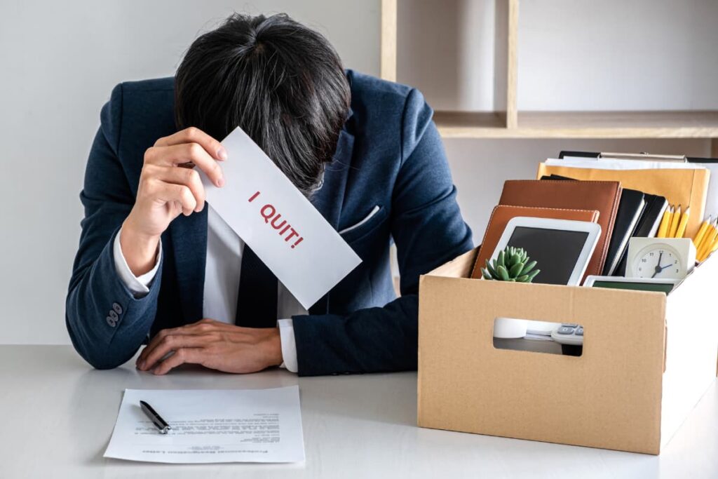 To Quit Walmart process, a person submitting his resignation letter and packed his belongings like clock, folders, ipad, pencils in a cardboard box. 