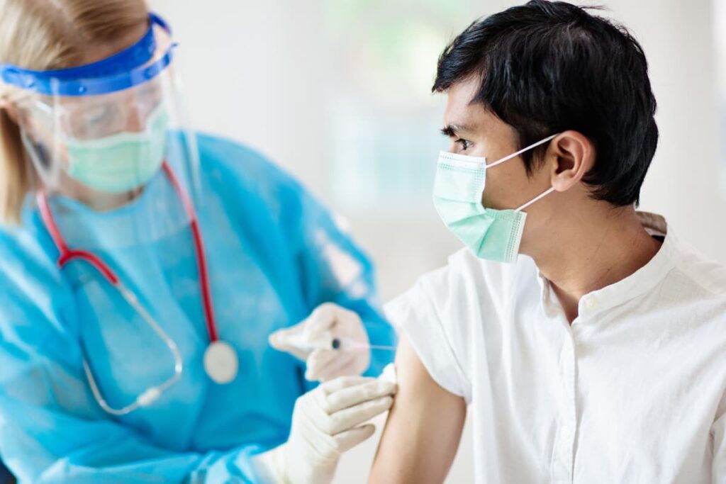 Walmart Covid Vaccine has taken a person from a doctor who wore face shield, stethoscope, Personal Protective Equipment kit and white surgical gloves.