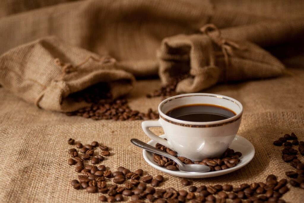 Walmart Coffee served with coffee beans along with cup, saucer and spoon.