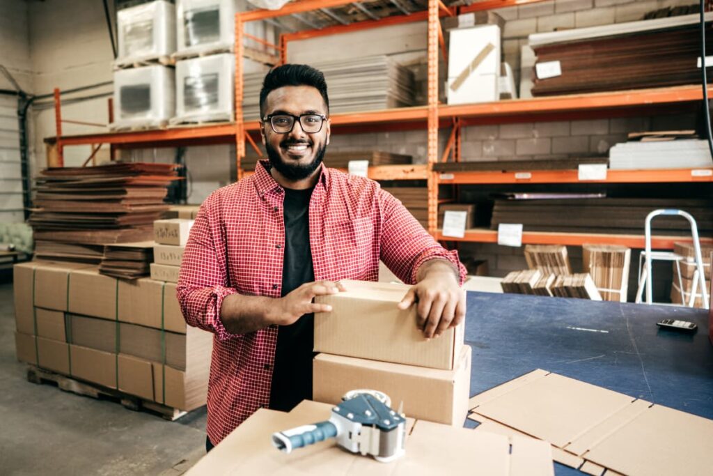 Walmart Package Handler moving packages and package boxes with the help of taping machine at Walmart Warehouse.