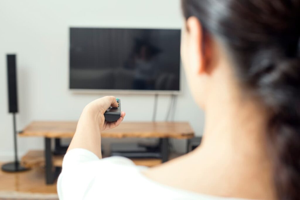 Walmart Roku used by a women while watching a tv sitting in her home.