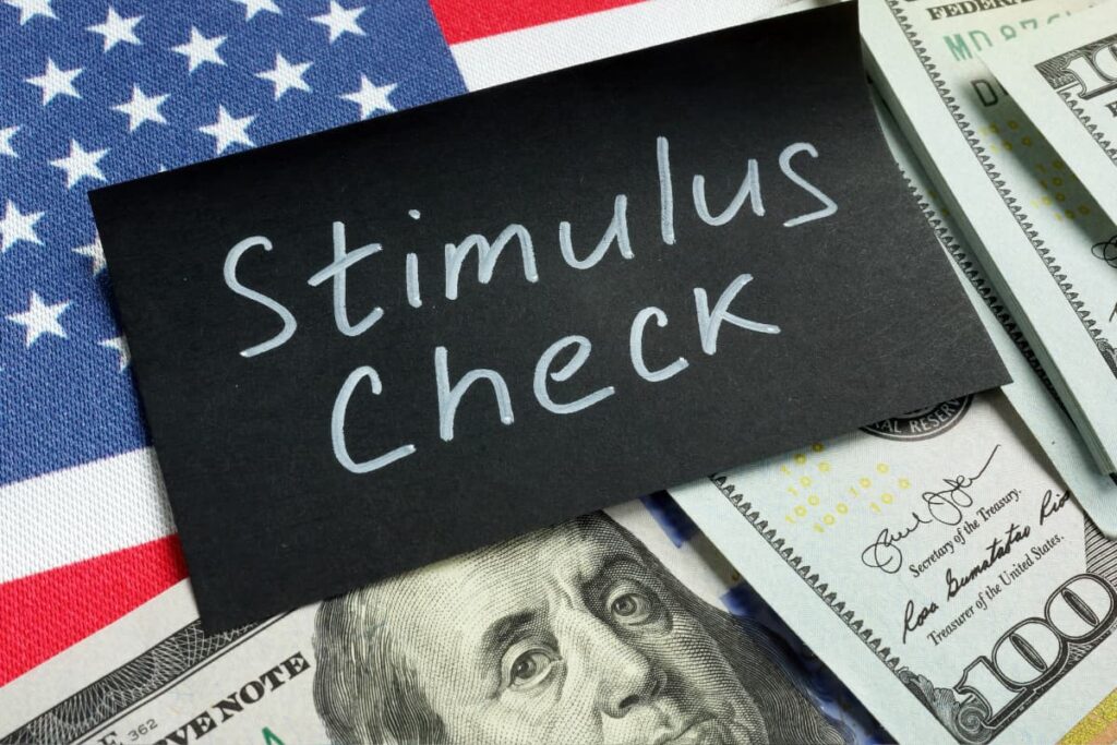 Walmart Stimulus Check along with some American dollars and American national flag appeared on a table.