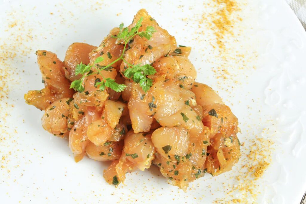 Chick Fil A Marinate Their Chicken using pepper, salt, turmeric, chilli powder, coriander for garnishing. The marinated chicken was kept in a paper towel, beside that some masala powder sprinkled.