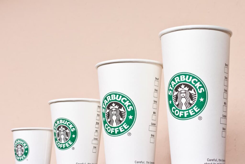 Starbucks Cups are available in different sizes. Here 4 different sizes of cups, which are white in color, and there is a starbucks coffee logo on it.