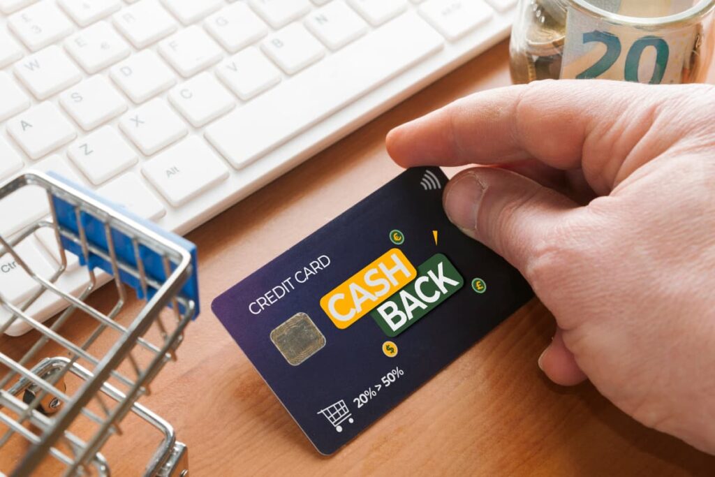 Cash Back at Publix get by using credit card, laptop, mini cart and some dollars jar on a wooden table.