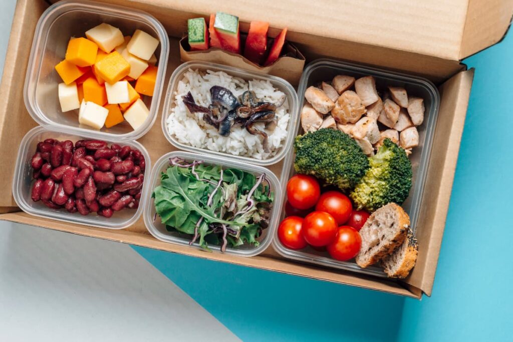 Starbucks Allow Outside Food, all food items are packed seperately and kept in a big brown box. Here papaya, red beans, green leaves, rice, brocoli, bread slices, chicken, tomatoes, watermelon all are kept different boxes.