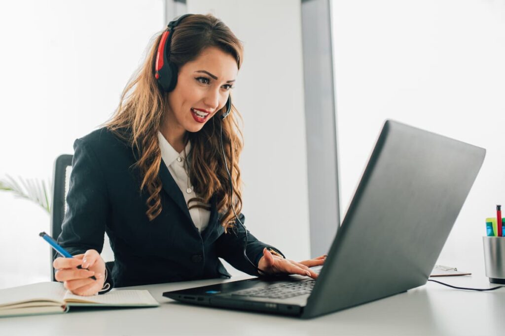 Call-Out Policy at Publix applied by a person through laptop, pen, headset, book on a working table.