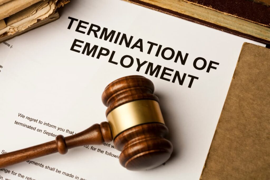 Termination Policy At Publix contains termination letter, files and Commercial Docket on a wooden table.
