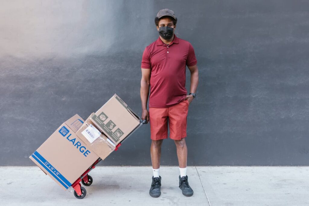 Instacart at Safeway delivered by a person with red color uniform along with three  shipping boxes.