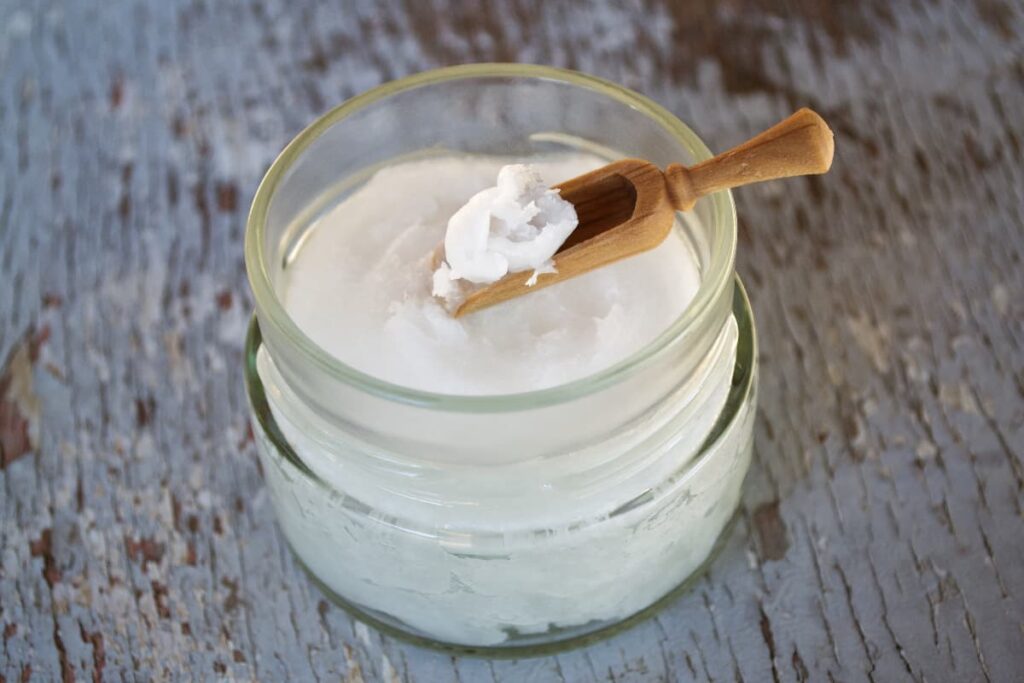 Starbucks cream can be served in glass jar. Starbucks cream is white in color and there is a wooden spoon on it.