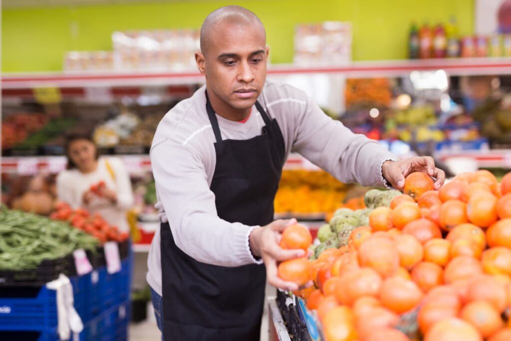 Restock at Safeway arranged fresh fruits and vegetables at the store.